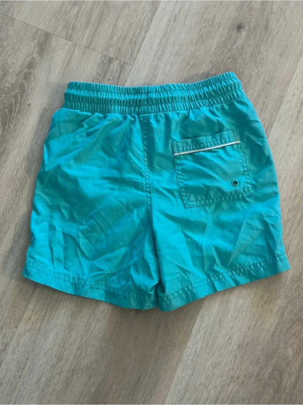 Boy’s Old Navy pull-on swim trunks in a bright teal- Size S (6-7)